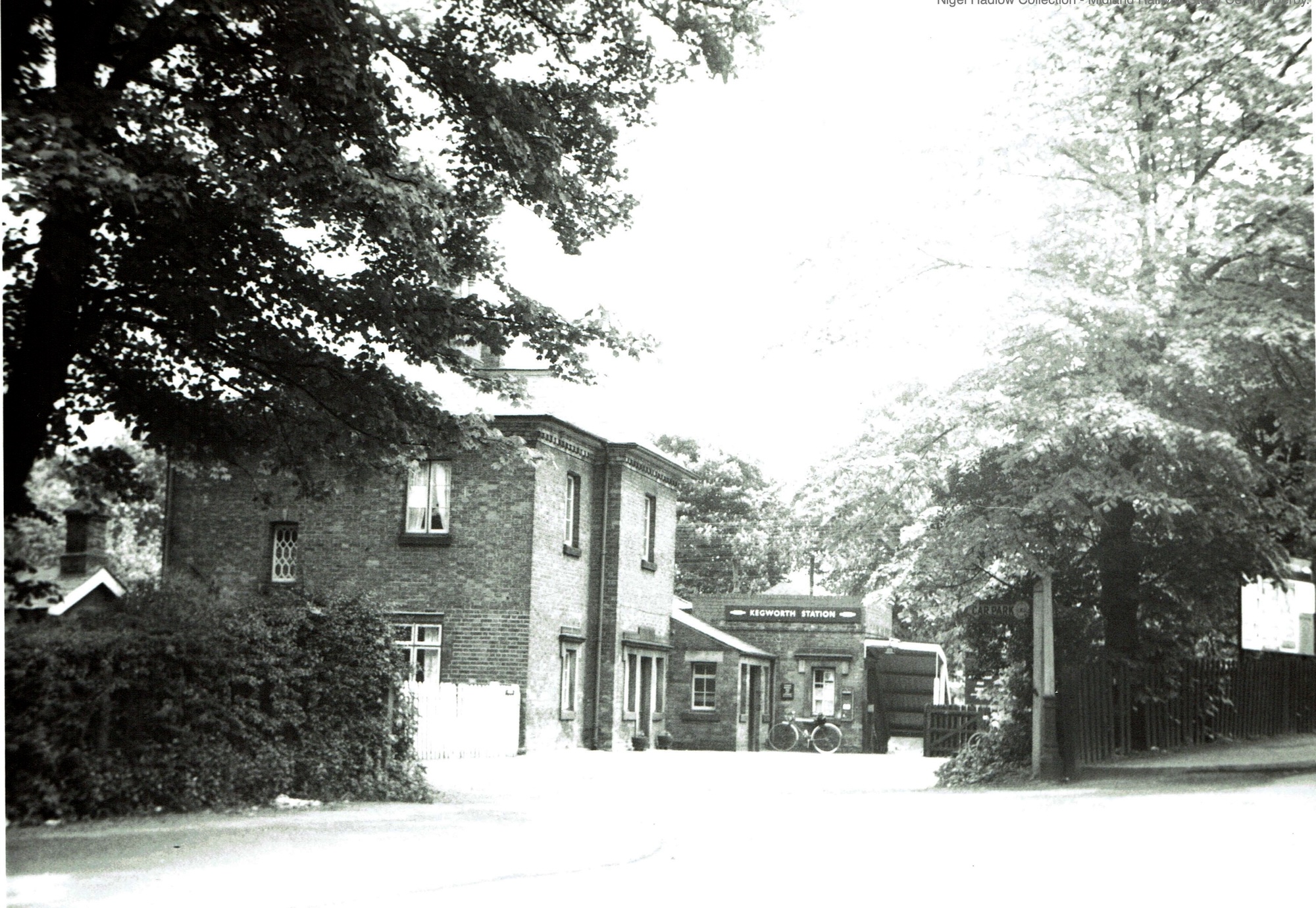 A 1960s black and white photograph showing the entrance to Kegworth station in its leafy surroundings.